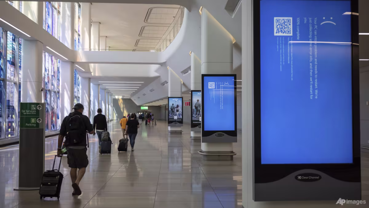 Airport walkway showing impacted screens from CrowdStrike outage.
